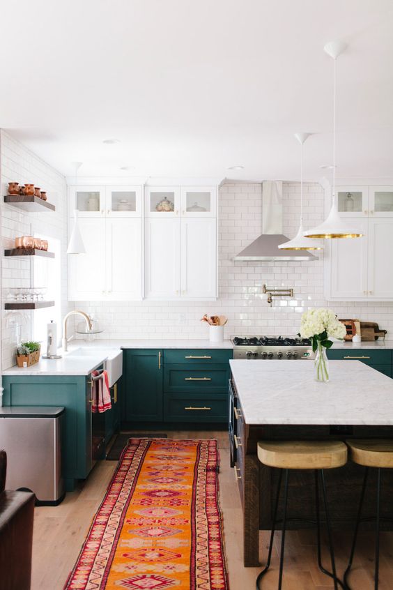 a chic kitchen with dark green and white cabinets, a white suwaby tile backsplash and open shelving a chic kitchen with dark green and white cabinets, a white suwaby tile backsplash and open shelving