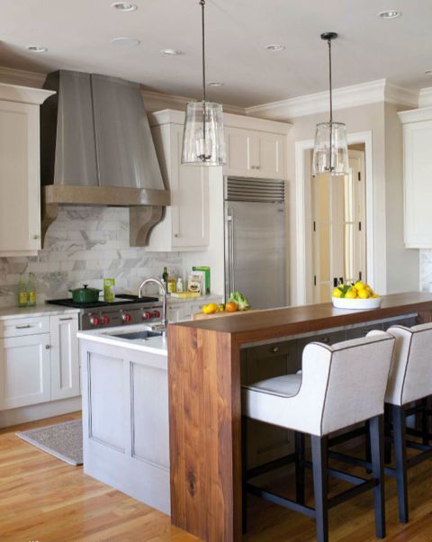 the kitchen island fits into the kitchen decor and a wooden countertop fits into the space around it