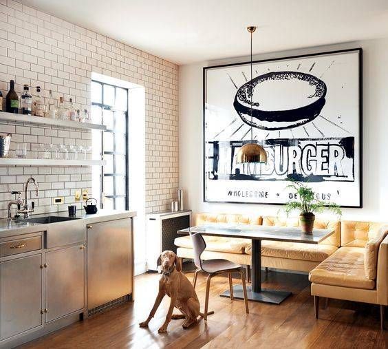 a nook with a corner sofa and a comfy table spruced up with a large artwork adds color and interest