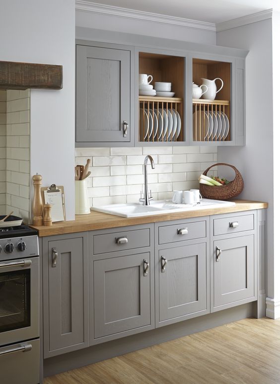 vintage grey kitchen is softened with wooden countertops and a subway tile backsplash makes it more eye-catchy
