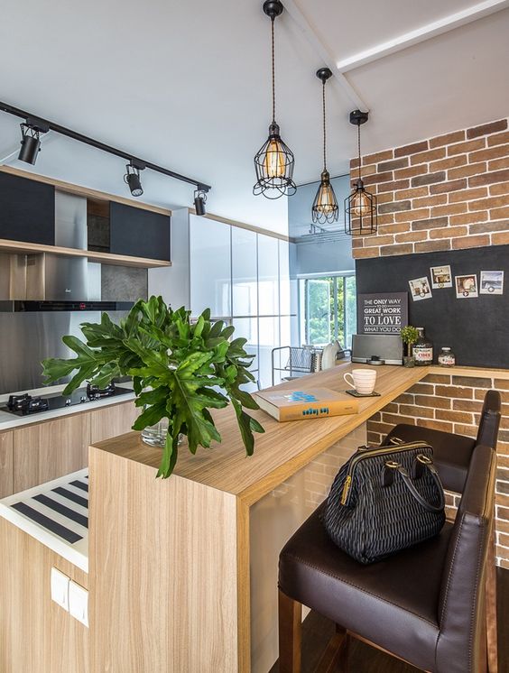 a wooden kitchen island in a modern space is made chic with brown leather stools