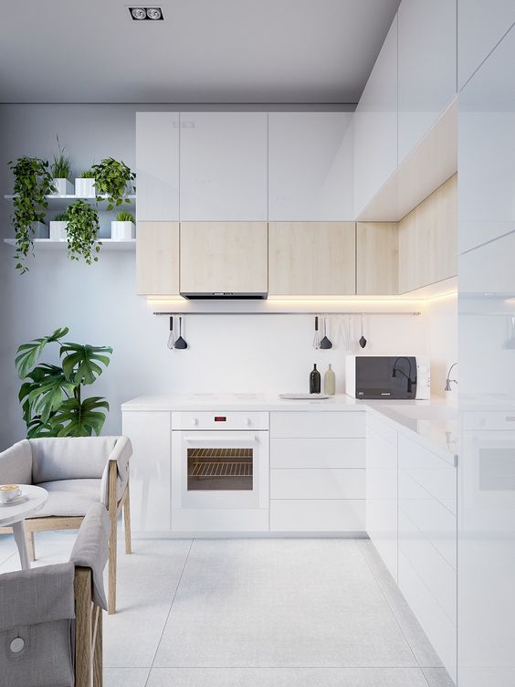 a small modern kitchen nook with cabinets covered with light-colored wood for giving it a textural look