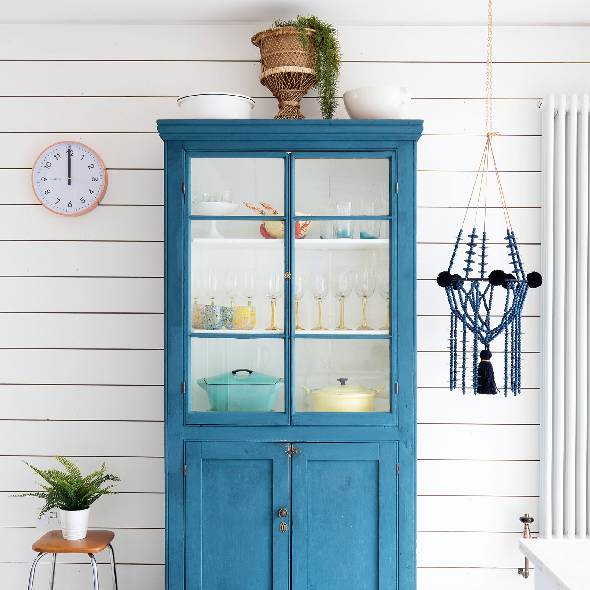 White kitchen with panelled wall and blue cabinet