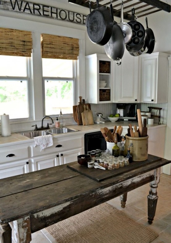 A weathered antique table could make a perfect kitchen island for a farmhouse.
