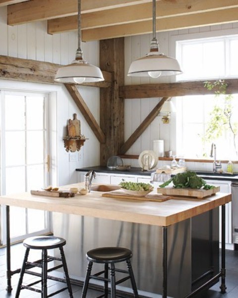 a pretty neutral barn kitchen with white planked walls, rough wooden beams, pendant lamps, a metal kitchen island with stools a pretty neutral barn kitchen with white planked walls, rough wooden beams, pendant lamps, a metal kitchen island with stools