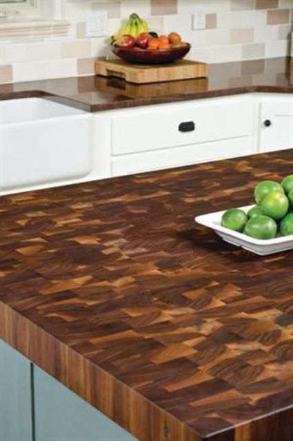a rich stained butcherblock countertop is a stylish idea for a rustic kitchen with white and aqua cabinets