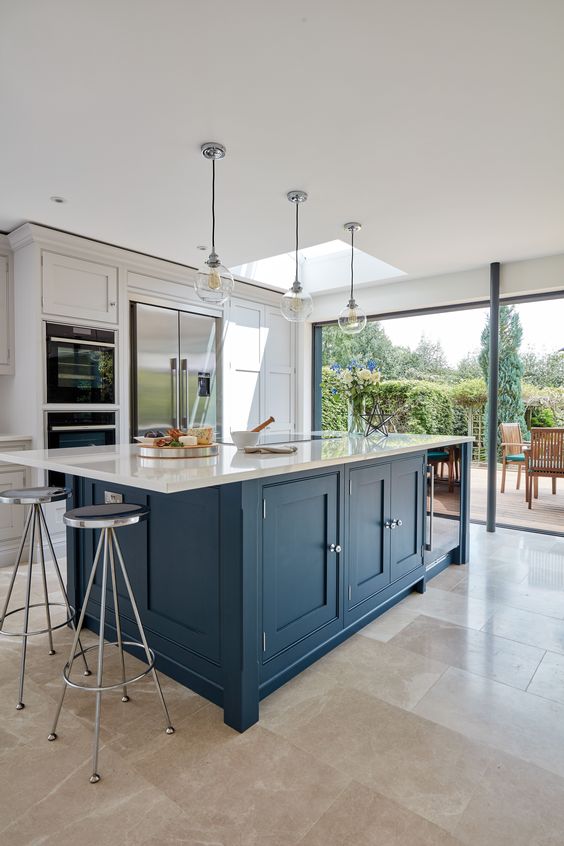 a dove grey kitchen with a large navy kitche