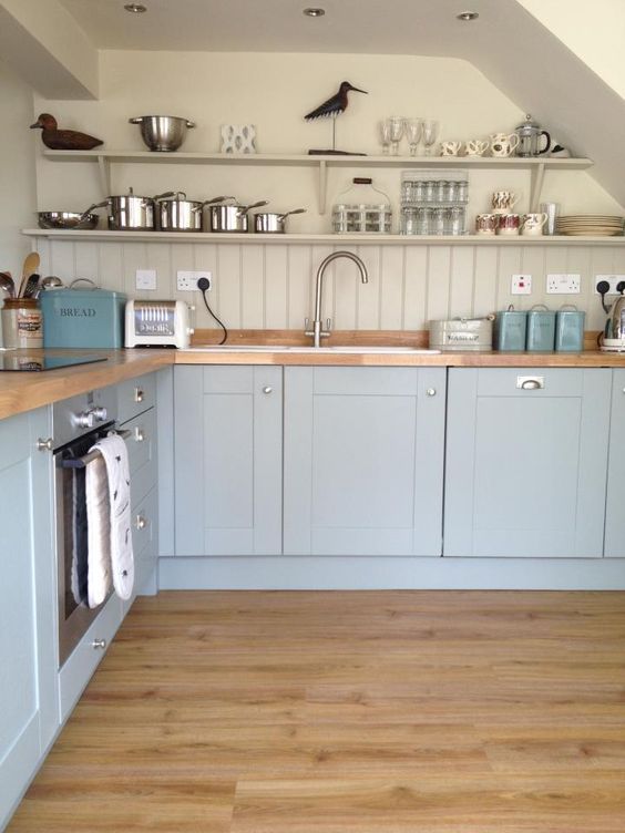 a light blue kitchen with a dove grey wall_y