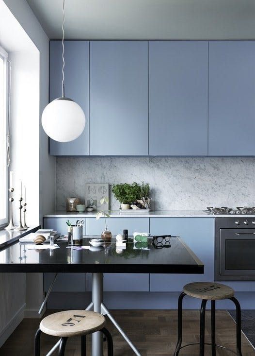 a minimalist light blue kitchen with a grey