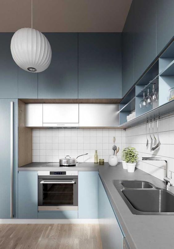 a minimalist light blue kitchen with grey additiona