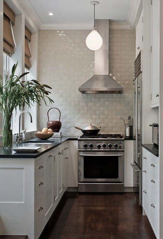 a small U shaped kitchen with a cooker and_y