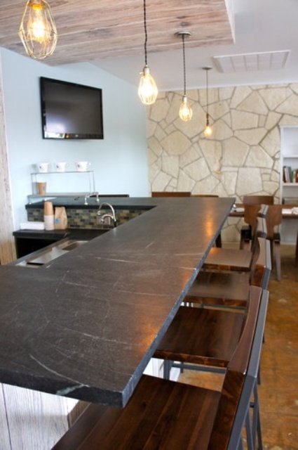 an elegant dark stone countertop_ a white kitchen_y