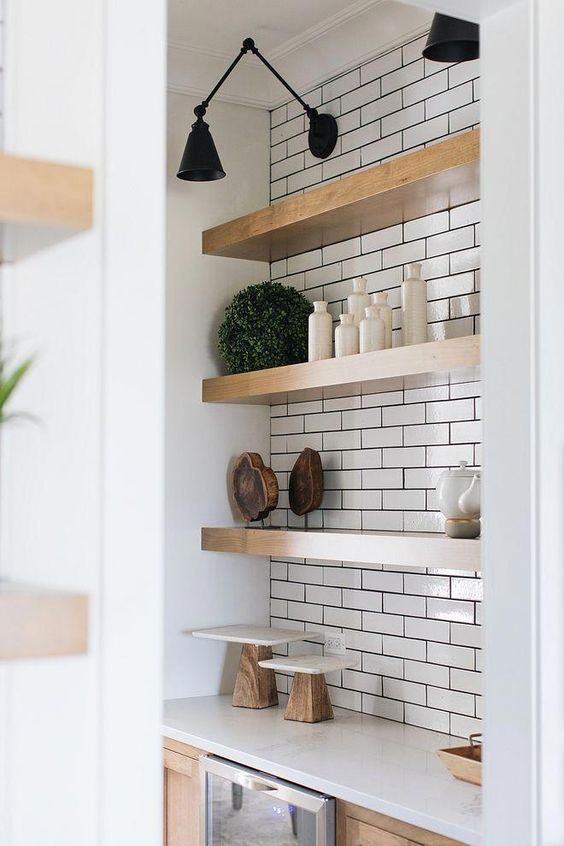 thick wooden shelves in a white tile niche l