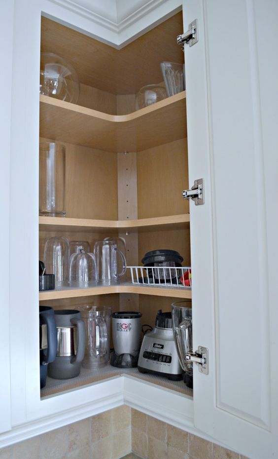 a-corner-cabinet-with-shelves-that-holds-appliances-and-various-mugs-and-glasses-is-a-cool-solution-