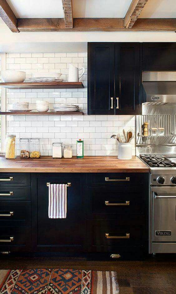 a farmhouse kitchen with black cabinets_ neutral bu
