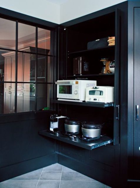 a-large-black-cabinet-holding-all-the-appliances-on-retractable-shelves-helps-to-keep-the-kitchen-in