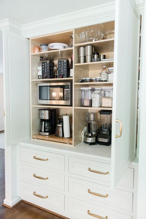 a-large-cabinet-with-all-kinds-of-appliances-some-bowls-and-jars-is-a-cool-idea-to-store-what-you-do
