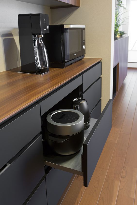 a-minimalist-black-kitchen-with-an-oversized-drawer-with-black-appliances-keep-the-kitchen-neater-an