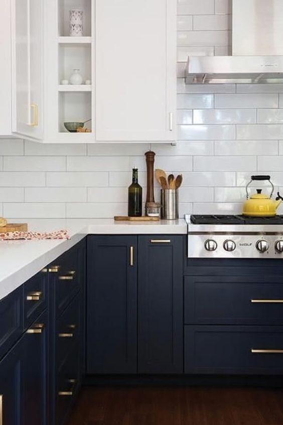 a trendy two tone kitchen with white and bla