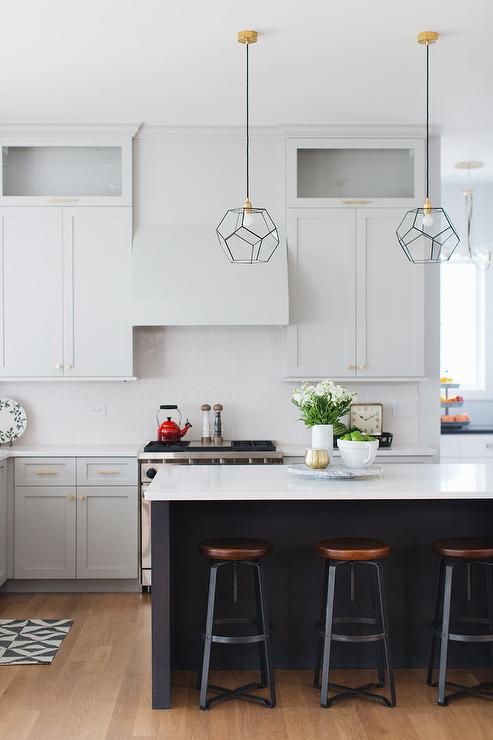 the black kitchen island features a white counterto